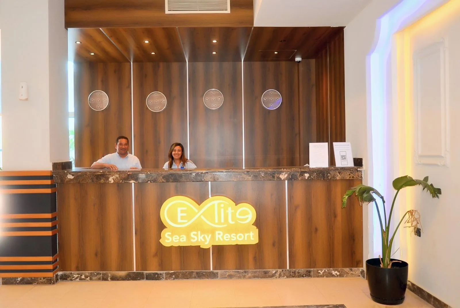The reception desk with the gold Elite Sea Sky logo